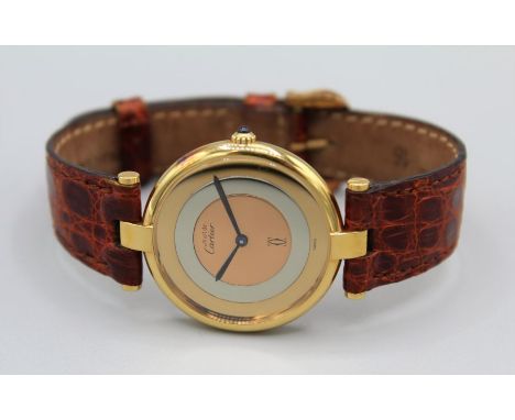 A 1990s vintage  Must De Cartier Ronde Ladies wrist watch in gold plated silver with a Cartier crocodile skin bracelet. With 