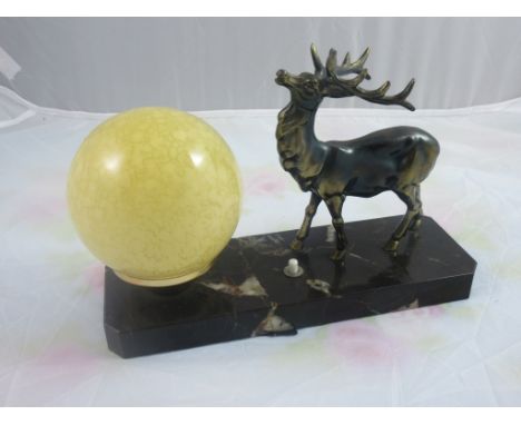 An Art Deco style Table Lamp, with a figure of a Stag and a glass lamp globe atop a marble stand, length approx 10''.