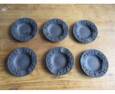 Six black Wedgwood Trinket Trays, or ashtrays, with moulded decorative garland border, each approx 9cm in diameter.