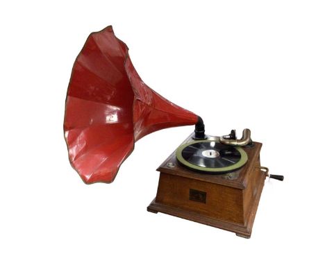 HMV oak cased gramophone with red-painted horn, in working order, together with a group of recordsWhen wound up it appears to