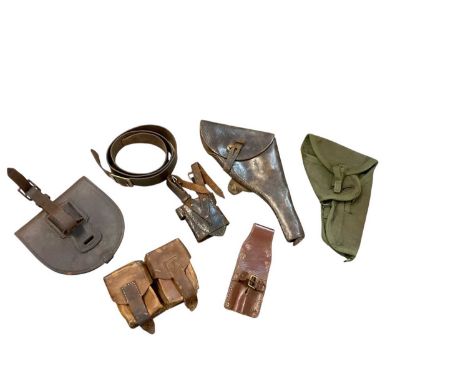 Second World War brown leather service revolver holster, a canvas webbing holster, two leather frogs and other leather pouche