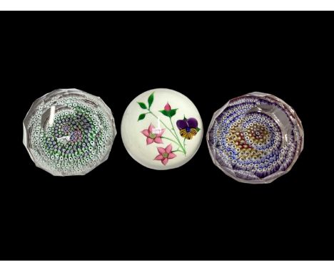 Three Whitefriars paperweights, including one titled 'Pansy', signed to base, and two faceted millefiori paperweights (one in