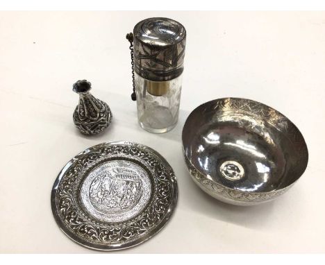 Four Eastern white metal items to include a glass perfume bottle, pin dish, small bowl and a miniature bottle vase