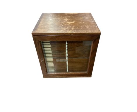 Early 20th century collectors' cabinet, with 28 numbered trays, glazed front, 40cm highThe draws are approximately 7mm deep -