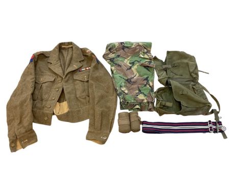 Group of assorted British Army uniform to include a 1949 pattern battle dress blouse, dated 1950, canvas webbing belts, stabl