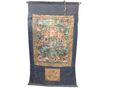 Antique Tibetan thangka wall scroll. Hand painted deity figures and gardens on cotton. Borders are brocade with a dragon pane