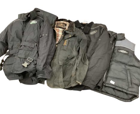 Group of motorcycle clothing to include helmets, together with vintage cases.The Royal Enfield wax jacket is a size smallThe 