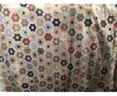 Antique patchwork quilt made of hexagon patches. 200 x 210cms approximately.This quilt has probably been rebacked. There is s