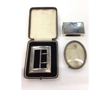 Late Victorian silver buckle, Mappin &amp; Webb silver matchbox holder and a small oval photograph frame (3)