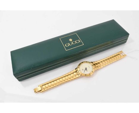 Gucci gold plated wristwatch with mother of pearl dial and Roman numeral makers to the bezel, 33mm diameter, numbered 3300M a