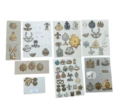 Group of eight boards mounted with a selection of British Military cap badges to include Artists Rifles, Army Ordnance Corps 