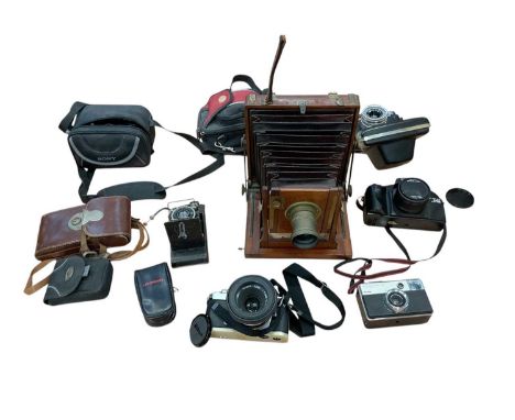 Collection of cameras and accessories, including an antique plate camera, Nikon FM with lens, etc (2 boxes)