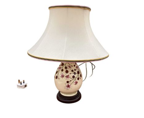 Moorcroft pottery table lamp decorated with flowers on cream ground