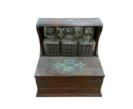 Edwardian oak cased three-bottle tantalusSound original condition, very dirty. All decanters in good order, very small nibble