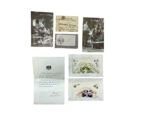First World War German Prisoner of War identification card, condolence slip and postcards.