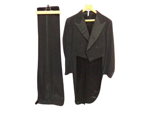 1949 Black tailcoat with matching button fly trousers.Jacket measured flat underarm to underarm 19", inside waist band 36", 3