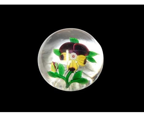 Baccarat paperweight decorated with a pansy, with star cut baseSome light scratching. Otherwise in good condition.