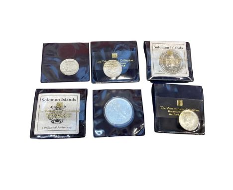 World - Mixed coinage &amp; stamp album to include silver U.S. fine silver 1oz coins x 2, silver Half Dollars x 4, Soloman Is