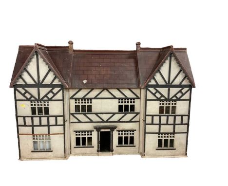 Large early 20th century Tudor-style dolls house with furniture, 124.5cm in length, 86cm in height.