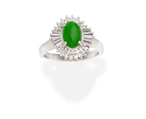 JADE AND DIAMOND RINGThe oval jadeite jade within a double brilliant-cut diamond surround, with tapered baguette-cut diamond 