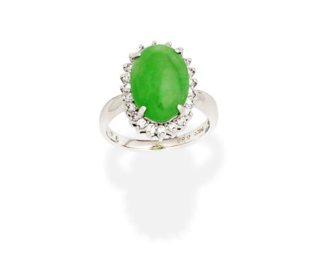 JADE AND DIAMOND RINGThe oval jadeite jade cabochon within a brilliant-cut diamond surround, diamonds approx. 0.25ct total, r