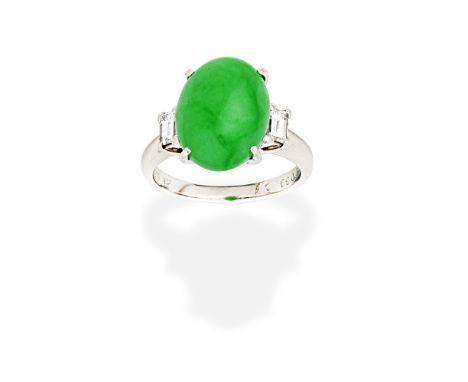 JADE AND DIAMOND RINGThe oval jadeite jade cabochon between baguette-cut diamonds,  diamonds approx. 0.35ct total, ring size 