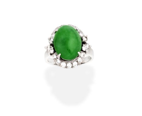 JADE AND DIAMOND RINGThe oval jadeite jade cabochon within a tiered, brilliant-cut diamond surround,  diamonds approx. 0.55ct