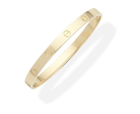 CARTIER: 'LOVE' BANGLEThe 18 carat gold bangle, decorated with screwhead motifs,  signed Cartier, numbered, European conventi