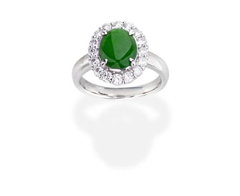 JADE AND DIAMOND RINGThe oval jadeite jade cabochon within a brilliant-cut diamond surround, diamonds approx. 0.45ct total, r