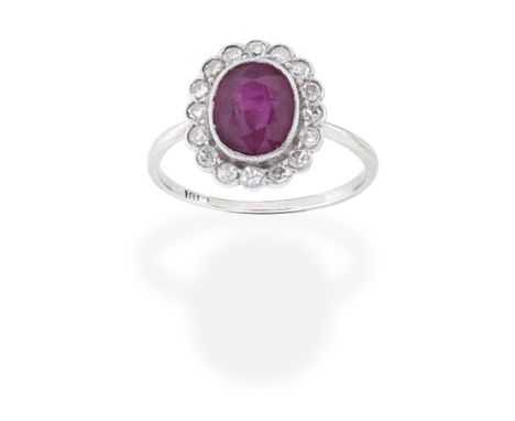 RUBY AND DIAMOND CLUSTER RINGThe oval-cut ruby, within a single-cut diamond surround, ring size approx. K½Footnotes:Please no