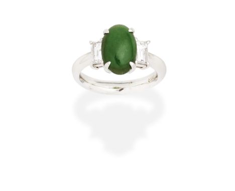 JADE AND DIAMOND RINGThe oval jadeite jade cabochon between baguette-cut diamond shoulders,  diamonds approx. 0.45ct total,  