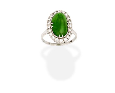 JADE AND DIAMOND RINGThe oval jadeite jade cabochon within a brilliant-cut diamond surround,  diamonds approx. 0.40ct total, 