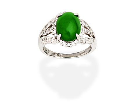 JADE AND DIAMOND RINGThe oval jadeite jade cabochon within a brilliant-cut diamond surround, between trifurcated shoulders se