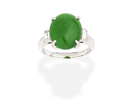 JADE AND DIAMOND RINGThe oval jadeite jade cabochon between baguette-cut diamond shoulders, diamonds approx. 0.20ct, ring siz