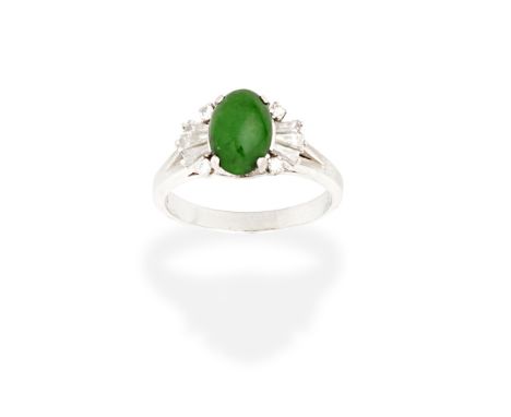 JADE AND DIAMOND RINGThe oval jadeite jade cabochon surrounded by four brilliant-cut diamonds, between trios of tapered bague
