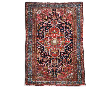 A Bakthiari rug, circa 1930,  of warm, rich palette with central madder medallion on a deep indigo ground203 x 133cm  Excelle