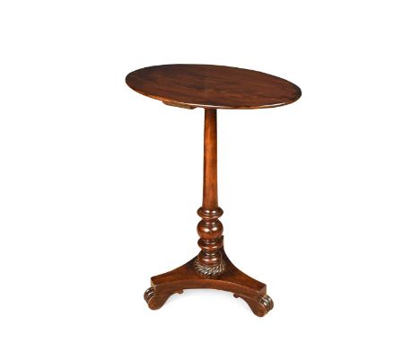 A Regency mahogany pedestal lamp table, the oval top raised on a turned column with wrythen socle above a tripartite base and