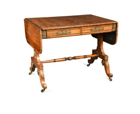 A Regency kingwood and gilt metal mounted sofa table, the rectangular crossbanded drop flap top over two frieze drawers raise