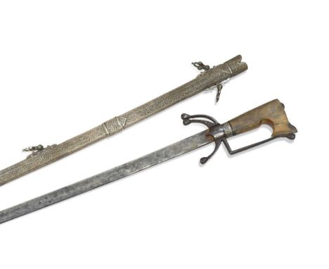 A North African sword, Nimcha, Morocco, 19th century,  with a slightly curved plain blade, the iron hilt with a pair of down 