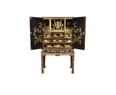 A Chinese Export lacquer and gilt cabinet on stand, late 18th or early 19th century,   the two doors opening to reveal a fitt