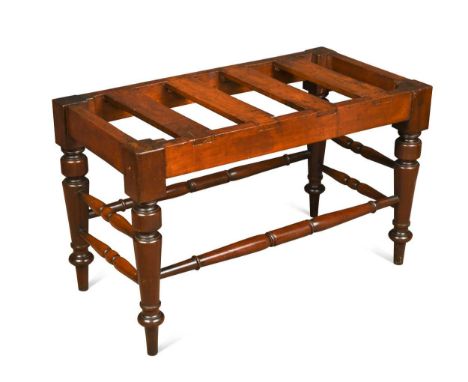 A good Victorian mahogany luggage stand,  of large scale with dovetailed slats and raised on turned legs united by turned str
