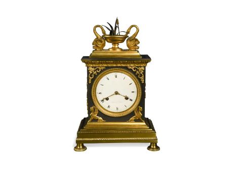 An Empire ormolu mantel clock signed Dubuc Le Jeune, early 19th century, the case surmounted with two swans drinking from a b