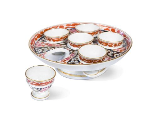 A Worcester, Flight and Barr egg cup stand for six egg cups, circa 1800, decorated in the 'Queen Charlotte' pattern, 20.5cm d