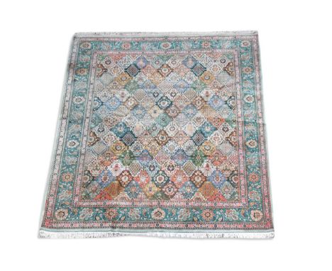 A large Tabriz 'garden design' carpet, the field of interlocking tile design each with a floral centre, all within a teal bor