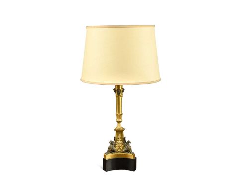 A gilt bronze neo-classical table lamp, 19th century,  the vase shaped column support with bacchanalian masks on a triform ba