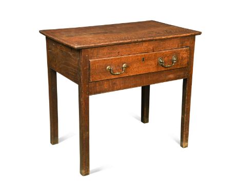 A small George III oak side table, the two plank cleated top over a central long drawer and two small side drawers raised on 