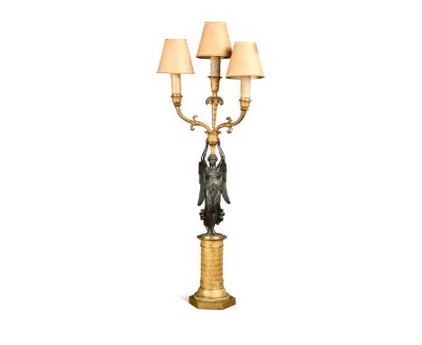 A three light gilt bronze candelabrum, 19th century, the winged figure possibly the goddess Nike on a gilt brass column decor
