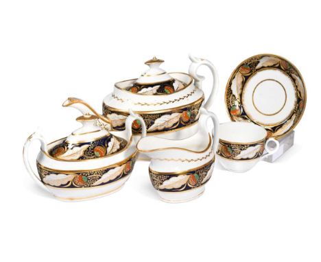 A Minton tea service, circa 1810, painted in green, iron red, blue and gold with broad borders of leaves and stylised flowers