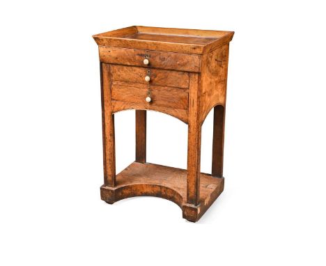 A Biedermeier walnut night table, 19th century, the tray top over three long drawers raised on square section legs united by 