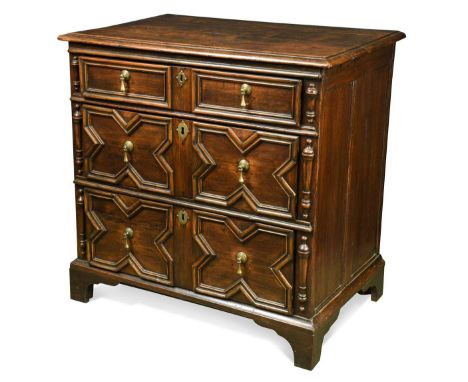 An oak geometric chest of drawers, late 17th century, comprising two short over two long geometrically moulded drawers flanke
